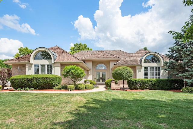 17 Ruffled Feathers Dr, Lemont, IL 60439 - view of front of property with french doors, a front lawn, stucco siding, and brick siding