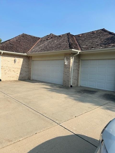 17 Ruffled Feathers Dr, Lemont, IL 60439 - view of front of house featuring brick siding, an attached garage, and concrete driveway