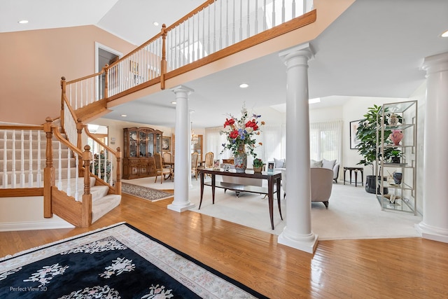 17 Ruffled Feathers Dr, Lemont, IL 60439 - foyer featuring ornate columns, wood finished floors, stairs, and high vaulted ceiling