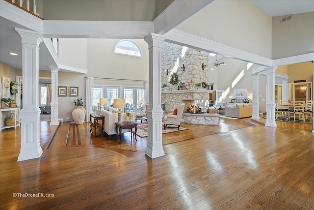 1417 Sherwood Ln, Geneva, IL 60134 - foyer with a high ceiling, wood finished floors, decorative columns, and a stone fireplace