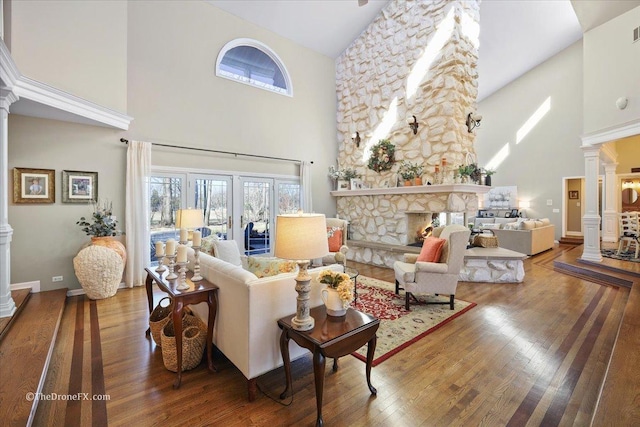 1417 Sherwood Ln, Geneva, IL 60134 - living area featuring decorative columns, high vaulted ceiling, wood finished floors, and a fireplace