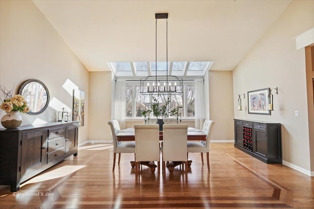 1417 Sherwood Ln, Geneva, IL 60134 - dining space featuring a chandelier, light wood-style floors, and a skylight