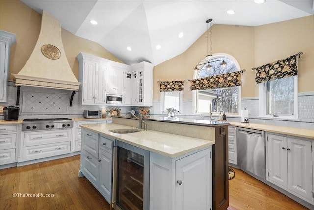 1417 Sherwood Ln, Geneva, IL 60134 - kitchen with beverage cooler, appliances with stainless steel finishes, premium range hood, white cabinets, and high vaulted ceiling