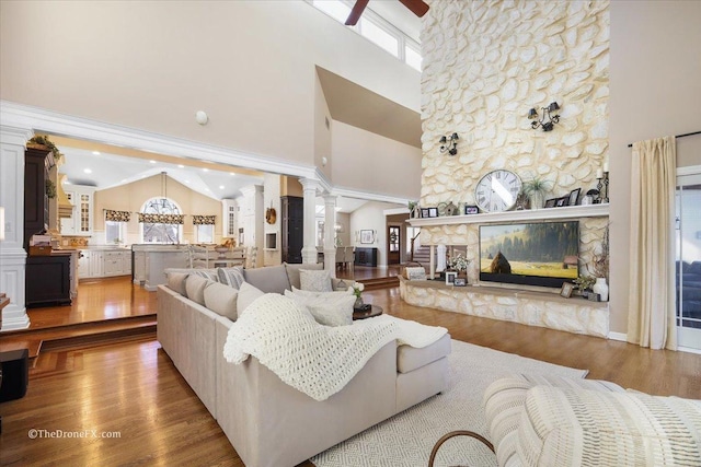 1417 Sherwood Ln, Geneva, IL 60134 - living area featuring decorative columns, healthy amount of natural light, a ceiling fan, wood finished floors, and high vaulted ceiling