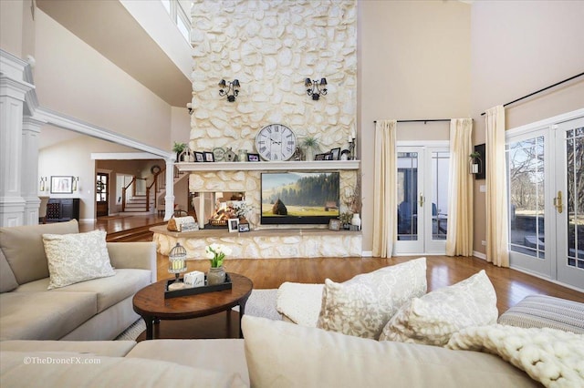 1417 Sherwood Ln, Geneva, IL 60134 - living room with a towering ceiling, decorative columns, french doors, wood finished floors, and stairs