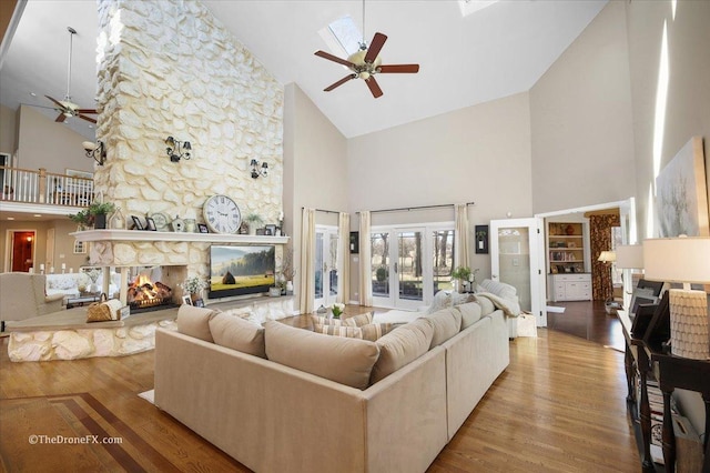 1417 Sherwood Ln, Geneva, IL 60134 - living area with ceiling fan, high vaulted ceiling, wood finished floors, and a stone fireplace