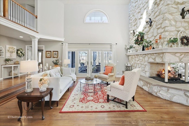1417 Sherwood Ln, Geneva, IL 60134 - living room featuring a towering ceiling, wood finished floors, plenty of natural light, and a stone fireplace