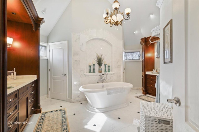 1417 Sherwood Ln, Geneva, IL 60134 - bathroom with high vaulted ceiling, two vanities, a soaking tub, and a chandelier