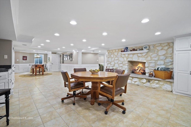 1417 Sherwood Ln, Geneva, IL 60134 - dining room featuring ornamental molding, a stone fireplace, a decorative wall, recessed lighting, and wainscoting