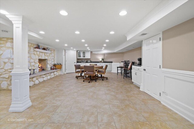 1417 Sherwood Ln, Geneva, IL 60134 - dining area with crown molding, ornate columns, a stone fireplace, recessed lighting, and light tile patterned flooring