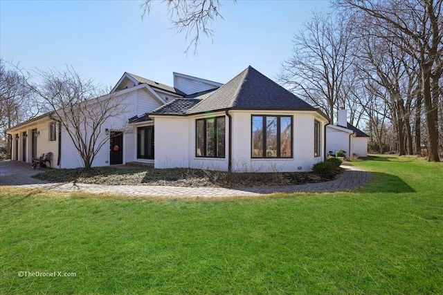 1417 Sherwood Ln, Geneva, IL 60134 - view of property exterior with a chimney, brick siding, a lawn, an attached garage, and driveway