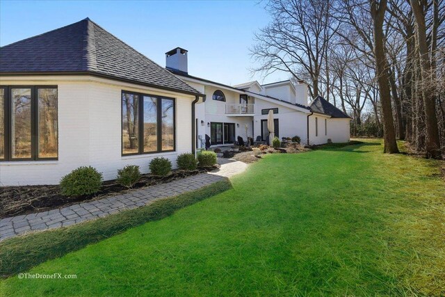 1417 Sherwood Ln, Geneva, IL 60134 - back of house featuring a chimney, a balcony, a lawn, and a shingled roof