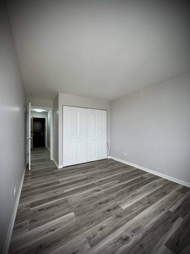 9720 S Pulaski Rd Unit 306, Oak Lawn, IL 60453 - unfurnished bedroom with dark wood finished floors and a closet