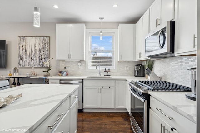 1449 E 65th Pl Unit 1, Chicago, IL 60637 - kitchen with appliances with stainless steel finishes, dark wood-style floors, white cabinetry, pendant lighting, and recessed lighting