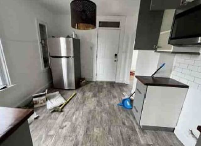 2626 W 96th Pl, Evergreen Park, IL 60805 - kitchen with freestanding refrigerator, wood finished floors, and dark countertops
