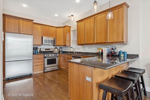 821 W Wrightwood Ave Unit 3, Chicago, IL 60614 - kitchen with stainless steel appliances, brown cabinets, dark wood-type flooring, a peninsula, and recessed lighting