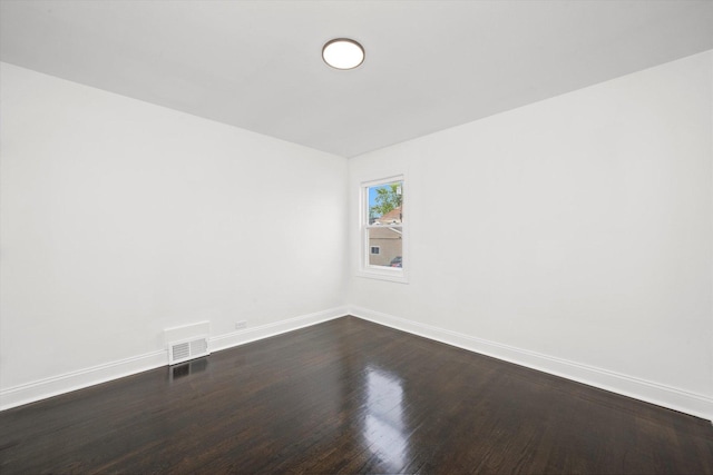 8637 S Honore St, Chicago, IL 60620 - spare room with baseboards and dark wood-type flooring