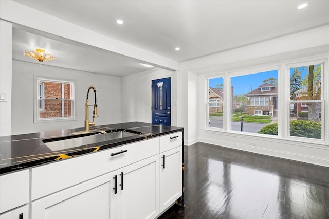 8637 S Honore St, Chicago, IL 60620 - kitchen with recessed lighting, dark wood finished floors, white cabinets, and dark countertops