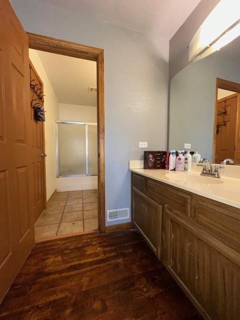 124 Village Creek Dr, Lake In The Hills, IL 60156 - bathroom featuring wood finished floors, a shower stall, and vanity