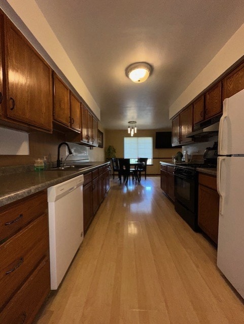 124 Village Creek Dr, Lake In The Hills, IL 60156 - kitchen with white appliances, under cabinet range hood, light wood-style flooring, and dark countertops