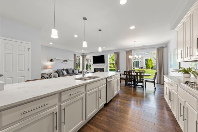 27W120 Timber Creek Dr, Winfield, IL 60190 - kitchen with stainless steel dishwasher, a lit fireplace, open floor plan, recessed lighting, and dark wood finished floors