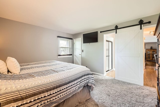 905 Harrison Ln, Hoffman Estates, IL 60192 - carpeted bedroom featuring a barn door and baseboards