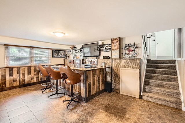 905 Harrison Ln, Hoffman Estates, IL 60192 - indoor dry bar with stairway, wooden walls, and a wainscoted wall