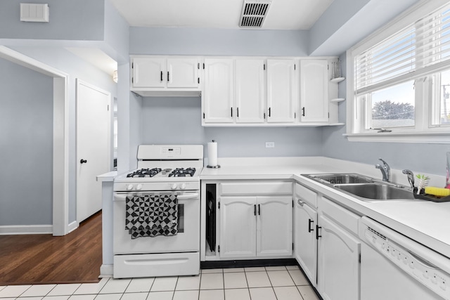 10341 Canterbury St, Westchester, IL 60154 - kitchen with white appliances, white cabinets, light countertops, and light tile patterned floors
