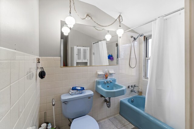 10341 Canterbury St, Westchester, IL 60154 - bathroom featuring tile walls, shower / bath combo with shower curtain, tile patterned floors, and vaulted ceiling