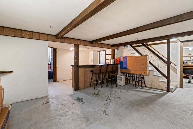 10341 Canterbury St, Westchester, IL 60154 - indoor dry bar with unfinished concrete flooring, stairs, and beamed ceiling
