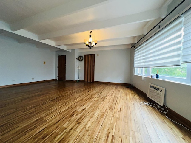 1950 W Hood Ave Unit 4C, Chicago, IL 60660 - unfurnished room with beamed ceiling, wood finished floors, a wall mounted AC, and a chandelier