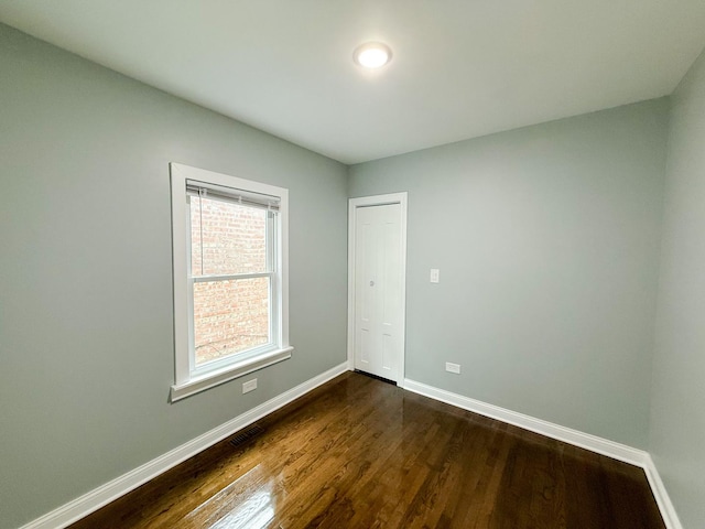 7252 S Wood St, Chicago, IL 60636 - unfurnished room featuring baseboards and dark wood-style floors