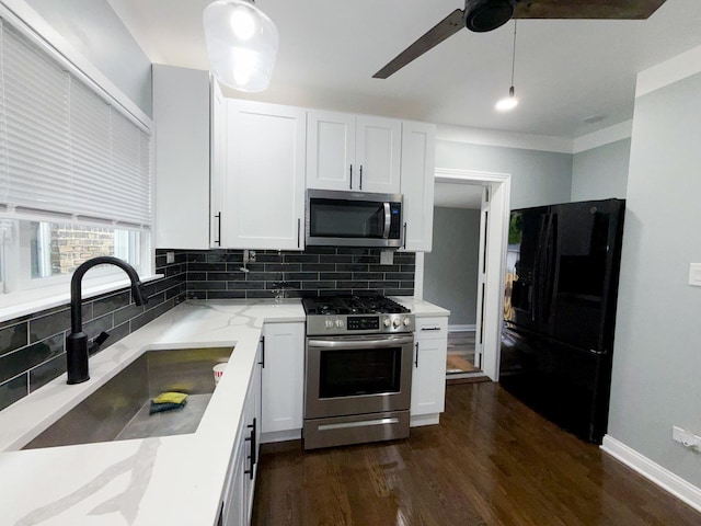 7252 S Wood St, Chicago, IL 60636 - kitchen with stainless steel appliances, light stone counters, white cabinetry, decorative backsplash, and dark wood-style floors
