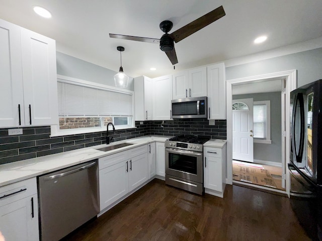 7252 S Wood St, Chicago, IL 60636 - kitchen with stainless steel appliances, a ceiling fan, white cabinetry, decorative backsplash, and dark wood finished floors