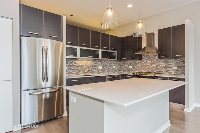 65 E Monroe St Unit 4010, Chicago, IL 60603 - kitchen with freestanding refrigerator, wall chimney exhaust hood, wood finished floors, backsplash, and recessed lighting