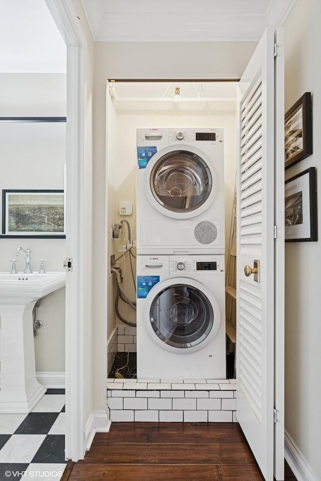 1250 N Dearborn St Unit 16B, Chicago, IL 60610 - laundry room featuring stacked washing machine and dryer and baseboards
