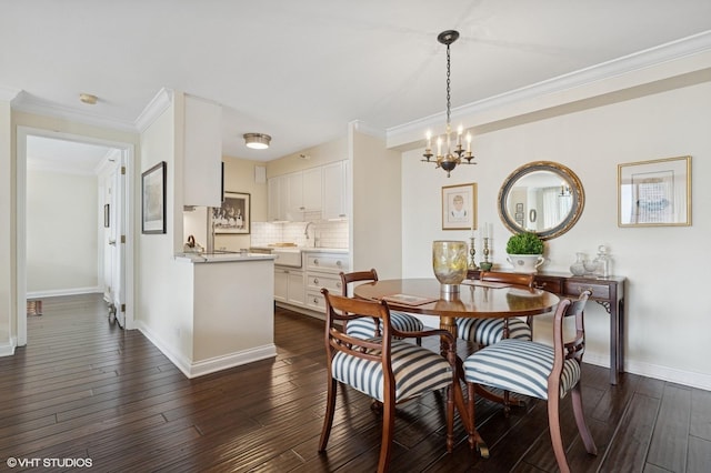 1250 N Dearborn St Unit 16B, Chicago, IL 60610 - dining space featuring a chandelier, dark wood-style flooring, and crown molding