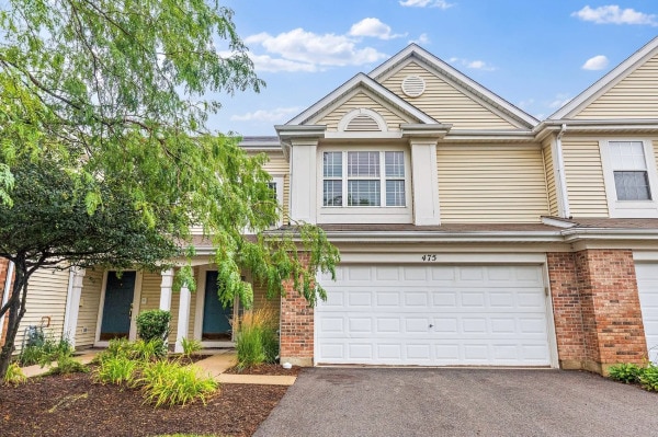 475 Lancaster Dr, Pingree Grove, IL 60140 - view of front facade with brick siding, a garage, and asphalt driveway