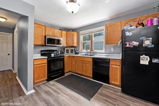 1923 Barbara Ln, South Beloit, IL 61080 - kitchen with black appliances, light countertops, and light wood-type flooring