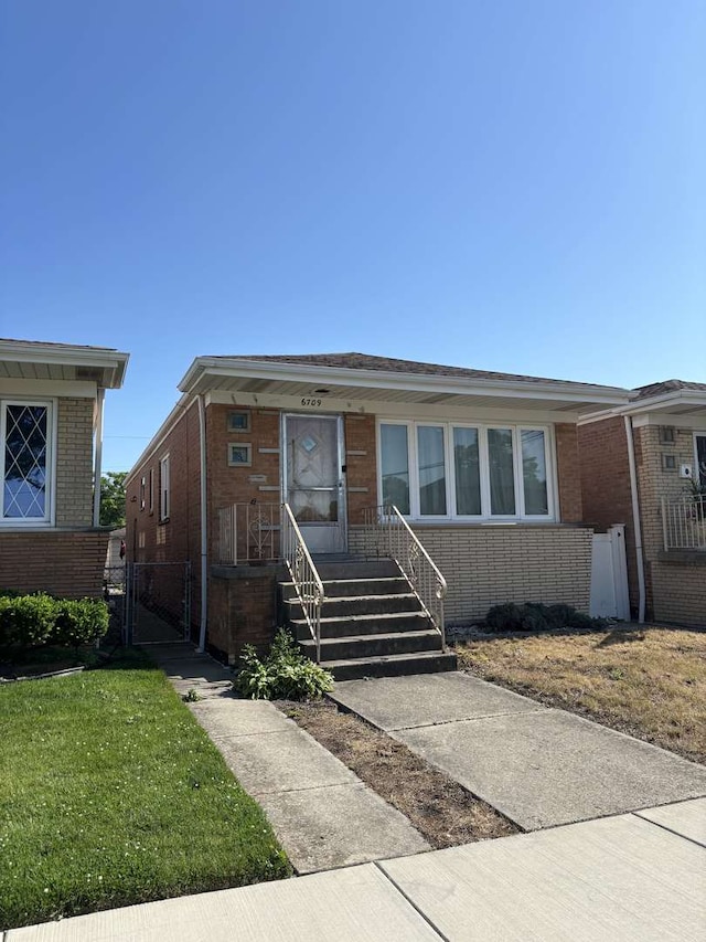 6709 W 59th St, Chicago, IL 60638 - view of front of property with brick siding and a front yard