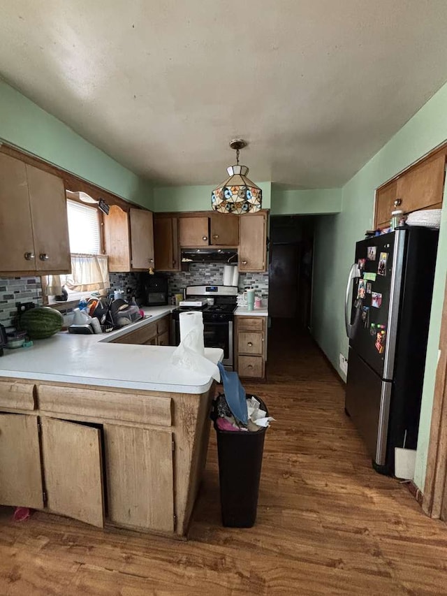 6709 W 59th St, Chicago, IL 60638 - kitchen with appliances with stainless steel finishes, under cabinet range hood, a peninsula, and dark wood finished floors