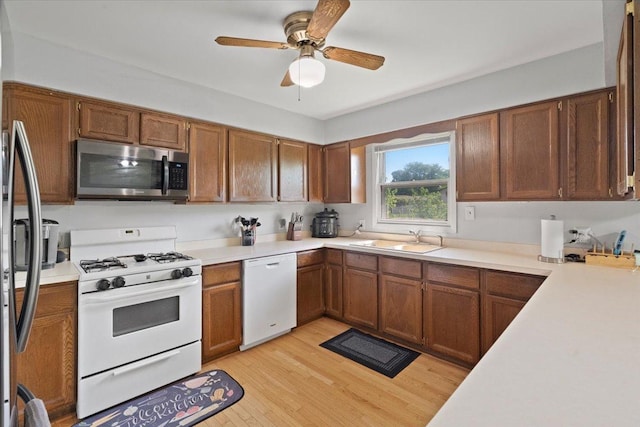 1514 N N Ave, Mchenry, IL 60050 - kitchen with appliances with stainless steel finishes, light wood finished floors, light countertops, a ceiling fan, and brown cabinets