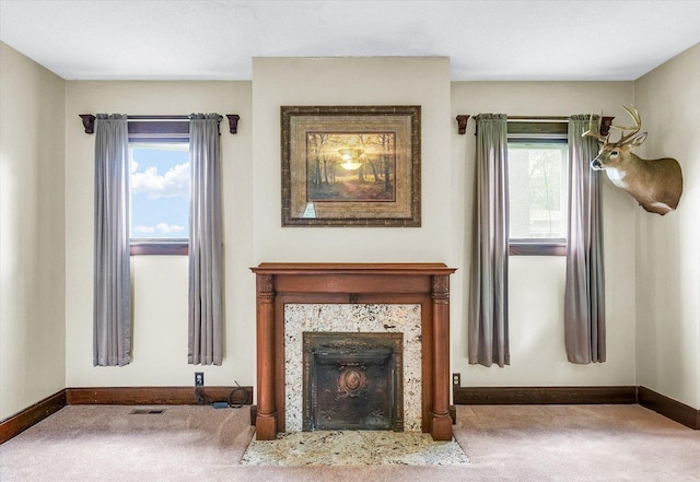 301 N Main St, Fithian, IL 61844 - unfurnished living room featuring carpet flooring and a tiled fireplace