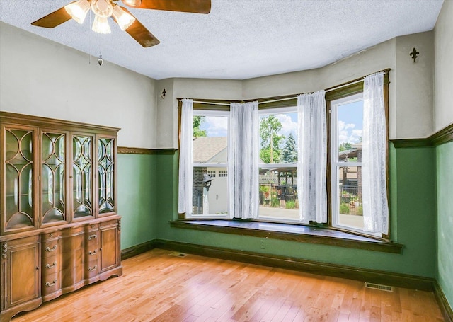 301 N Main St, Fithian, IL 61844 - spare room with ceiling fan, light wood finished floors, and a textured ceiling