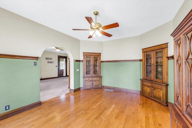 301 N Main St, Fithian, IL 61844 - unfurnished room with ceiling fan, arched walkways, light wood-style flooring, and a textured ceiling