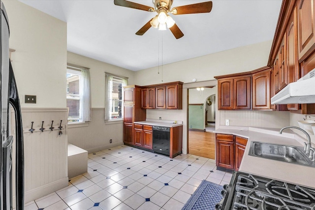 301 N Main St, Fithian, IL 61844 - kitchen featuring dishwasher, ceiling fan, a wainscoted wall, light countertops, and gas range