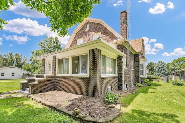 301 N Main St, Fithian, IL 61844 - view of side of home with a yard, brick siding, and a chimney