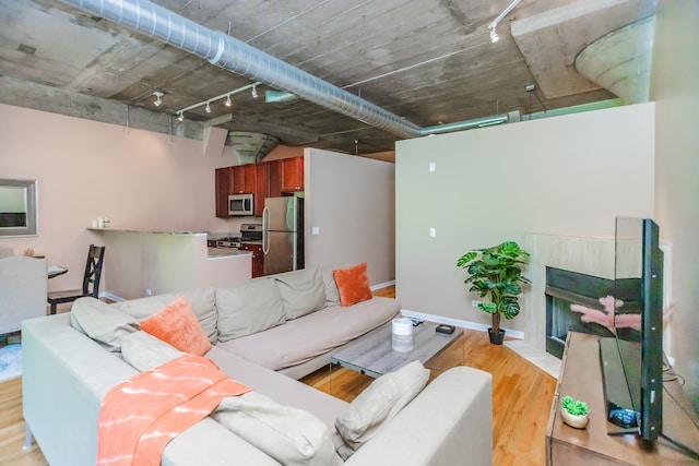 1070 W 15th St Unit 105, Chicago, IL 60608 - living area with track lighting, light wood-style flooring, and a fireplace with flush hearth