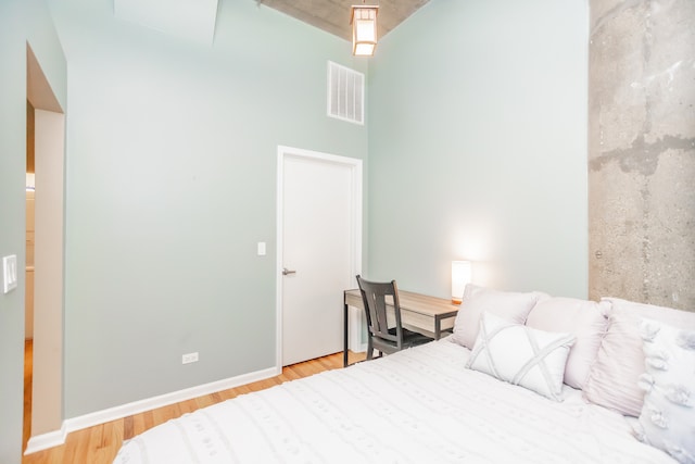 1070 W 15th St Unit 105, Chicago, IL 60608 - bedroom with a towering ceiling and wood finished floors