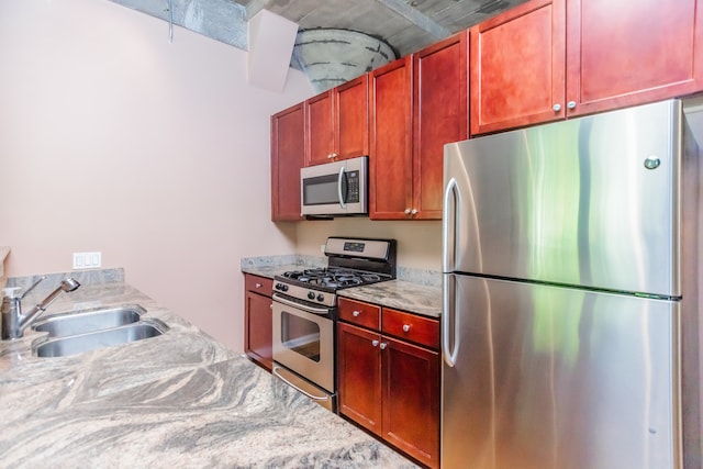 1070 W 15th St Unit 105, Chicago, IL 60608 - kitchen with stainless steel appliances and reddish brown cabinets